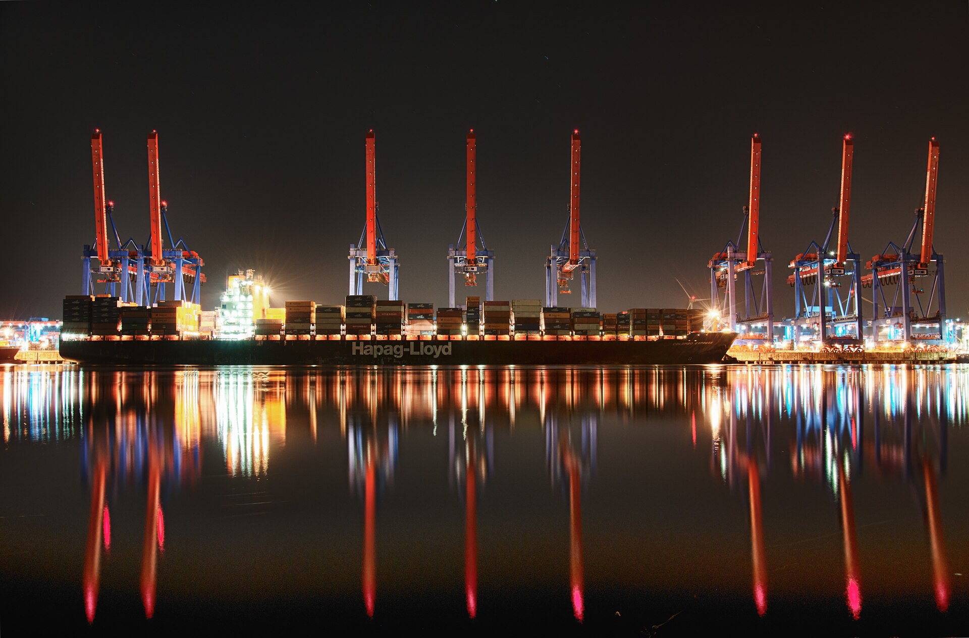 Container ship and cranes illuminated at night